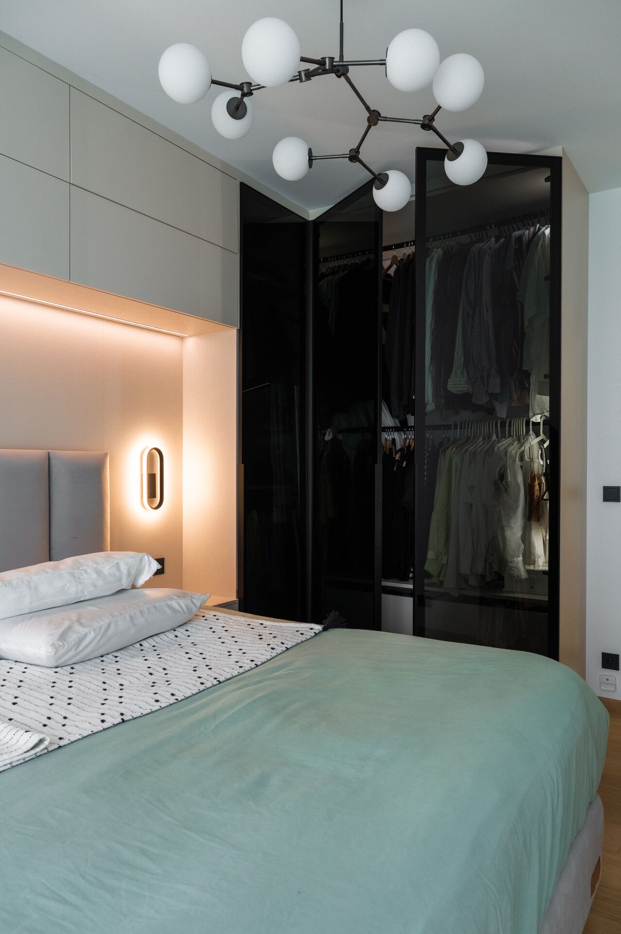 Bedroom with a black wardrobe with glazed doors